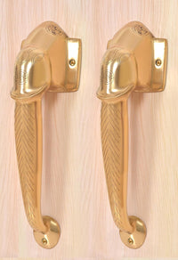 Gold-tone brass Ganesha face door handles with decorative chevron grip and round base