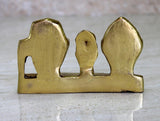 Back view of golden-finish brass idol base with hollow center and two side pillars