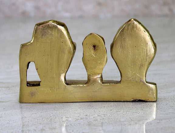 Back view of golden-finish brass idol base with hollow center and two side pillars