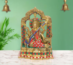 Brass Maa Saraswati idol, seated with veena, multicolor red-green details, decorative halo