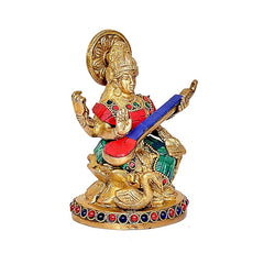 Maa Saraswati figurine with gold halo and red dress, green accents, blue veena