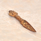 Brass Tibetan phurba dagger pendant with engraved vajra-style hilt and pointed blade tip