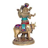 Brass Govinda cow idol, back/three-quarter view with enamel patterned outfit