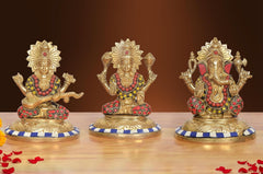 Multicolor brass Ganesh idol seated with raised hands and blue-striped base