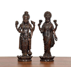 Front view of two brass standing idols of Lakshmi and Vishnu on lotus bases