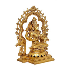 Brass Lakshmi statue in ornate arched frame, seated with arms at sides