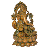 Brass Ganesha idol, rear 3/4 view with arched halo and layered ornaments