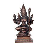 Copper-tone four-armed goddess sculpture holding trident and staffs, seated on pedestal