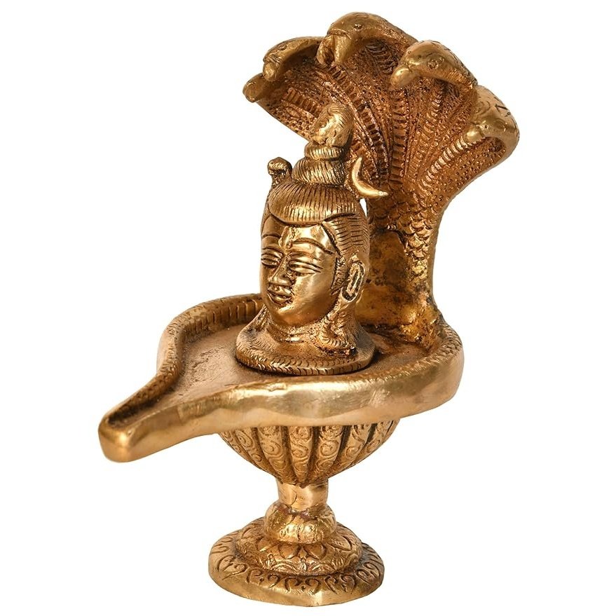 Brass Shiva linga figurine with seated face and ornate base, 6 in tall