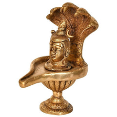Brass Shiva linga figurine with seated face and ornate base, 6 in tall