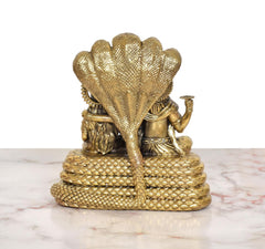 Rear view of brass Sheshnag base supporting seated Maa Lakshmi and Vishnu
