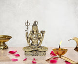 Fine brass Lord Shiva sculpture, seated on stone base, trident raised, 5 in