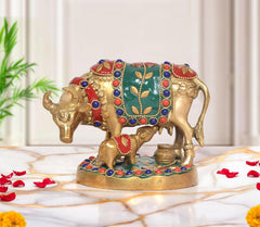 Brass cow with calf idol, green-red-blue jeweled saddle on round base, 4 inch
