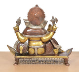 Back view brass Ganesha statue with large textured halo and seated feet on base