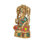 Gaja Lakshmi brass idol side view, teal and red jeweled garments with gold detailing.