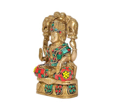 Gaja Lakshmi brass idol side view, teal and red jeweled garments with gold detailing.