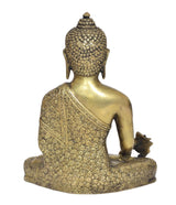 Brass meditating Buddha statue from behind, textured head and floral robe details