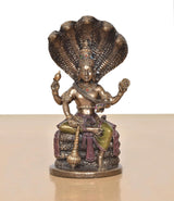 Vishnu resin figurine seated on Sheshnag coils, ornate crown, multicolor accents