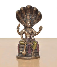Vishnu resin figurine seated on Sheshnag coils, ornate crown, multicolor accents