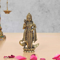 Standing brass Lord Kartikeya murti with peacock details, ornate jewelry on lotus base