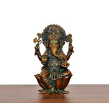 Lord Ganesha brass statue angled view, raised hands, ornate crown and painted motifs