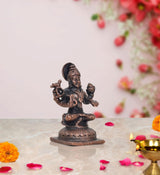Copper Sharadamba Devi statue, angled view, seated on pedestal, four hands