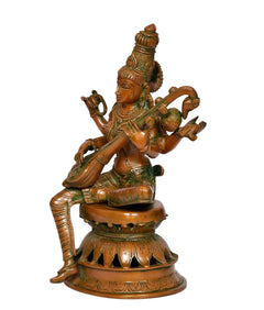 Brass Saraswati deity figurine with veena, side view showing sculpted arms and base