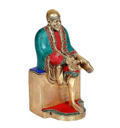 Shirdi Sai Baba idol on pedestal, teal robe, red sash, detailed face and jewelry
