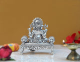 Brass Lord Ganesha sitting idol with decorative back halo and carved pedestal front