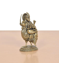 Bronze Bahuchara Mata idol three-quarter view, rooster near the seated figure on base