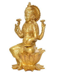 Brass Lakshmi idol side view with raised hands and detailed crown, seated on lotus