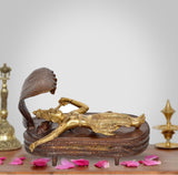 Brass Vishnu yoga nidra statue, reclining figure with cobra hood on circular base