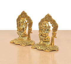 Golden metal Lakshmi and Ganesh statues from the side, raised detailing on back frames