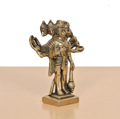 Angled view Panchmukhi Hanuman brass idol with five faces and carved garments on base