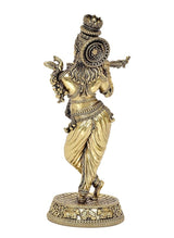 Rear view of gold-tone Lord Krishna idol playing flute on circular patterned base