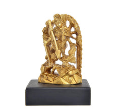 Golden brass Durga idol from side, arched halo design, on black base.