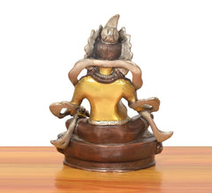 Brass Kuber Bhagwan murti, back view with arms framing the head and engraved base