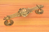 Brass door handle pair, golden finish, ornate bar with two round bases