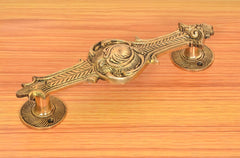 Brass door handle pair, golden finish, ornate bar with two round bases