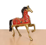 Brass running horse ornament, red body with decorative floral motifs and gold edges