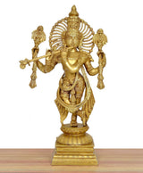 Gold-tone Krishna statue with flute, ornate headpiece and layered clothing, front view