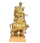 Brass standing Krishna with cow statue, rear view with large circular halo design