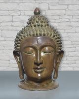 Brass Buddha head statue with serene face, curled hair texture, and elongated earlobes