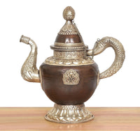 Traditional brass teapot with dark brown urn body, engraved front medallion, and curved handle