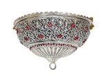Brass deity Chattar front view: ornate silver scrollwork with red gems, hanging finial