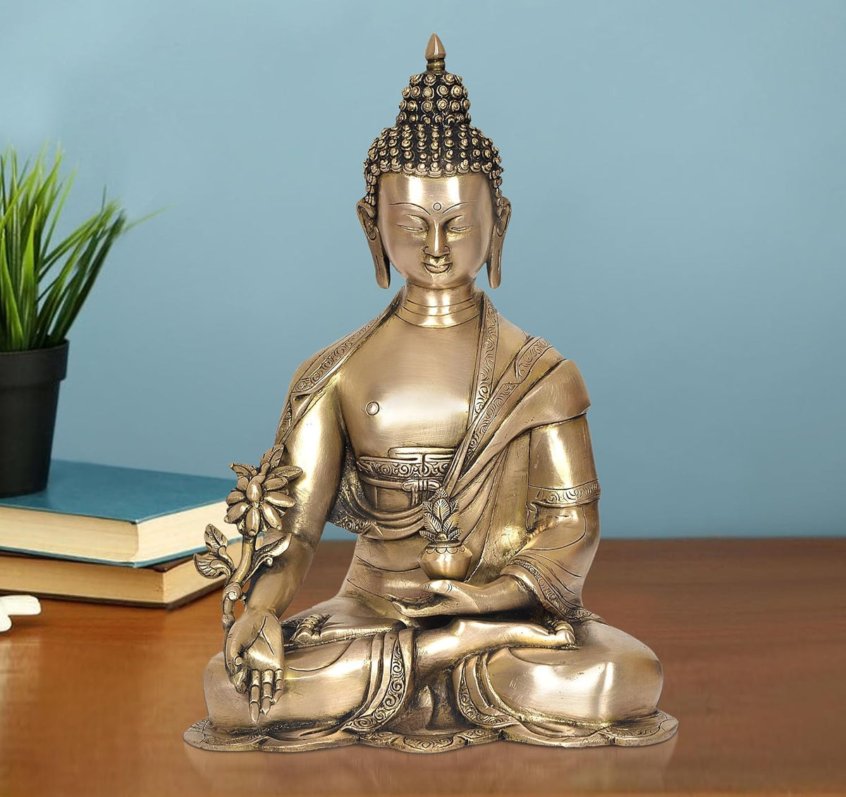 Brass meditating Buddha statue with lotus hand, seated posture, dark beaded hair