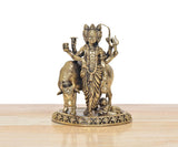 Side view of bronze Dattatreya Trimurti deity with curved arms and bull at base