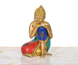 Sitting Buddha idol in brass finish, blue robe with red and teal mosaic details