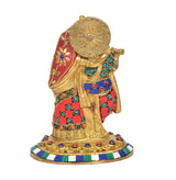 Brass Radha Krishna idol angled view, ornate halo and colorful jewel-studded outfit