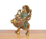 Brass Durga Maa on lion idol, left-side view, painted teal-red dress and crown